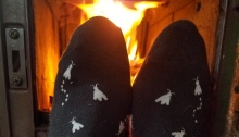 warming feet in front of a wood stove ©2019 Tuula Rebhahn